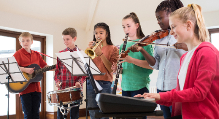 Six middle school students playing musical instruments 